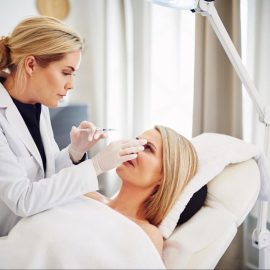 Dermatologist examining a patient's face in a UAE aesthetic clinic