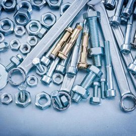 Assortment of anchor bolts, nuts and wrenches used when securing a safe locker in the UAE