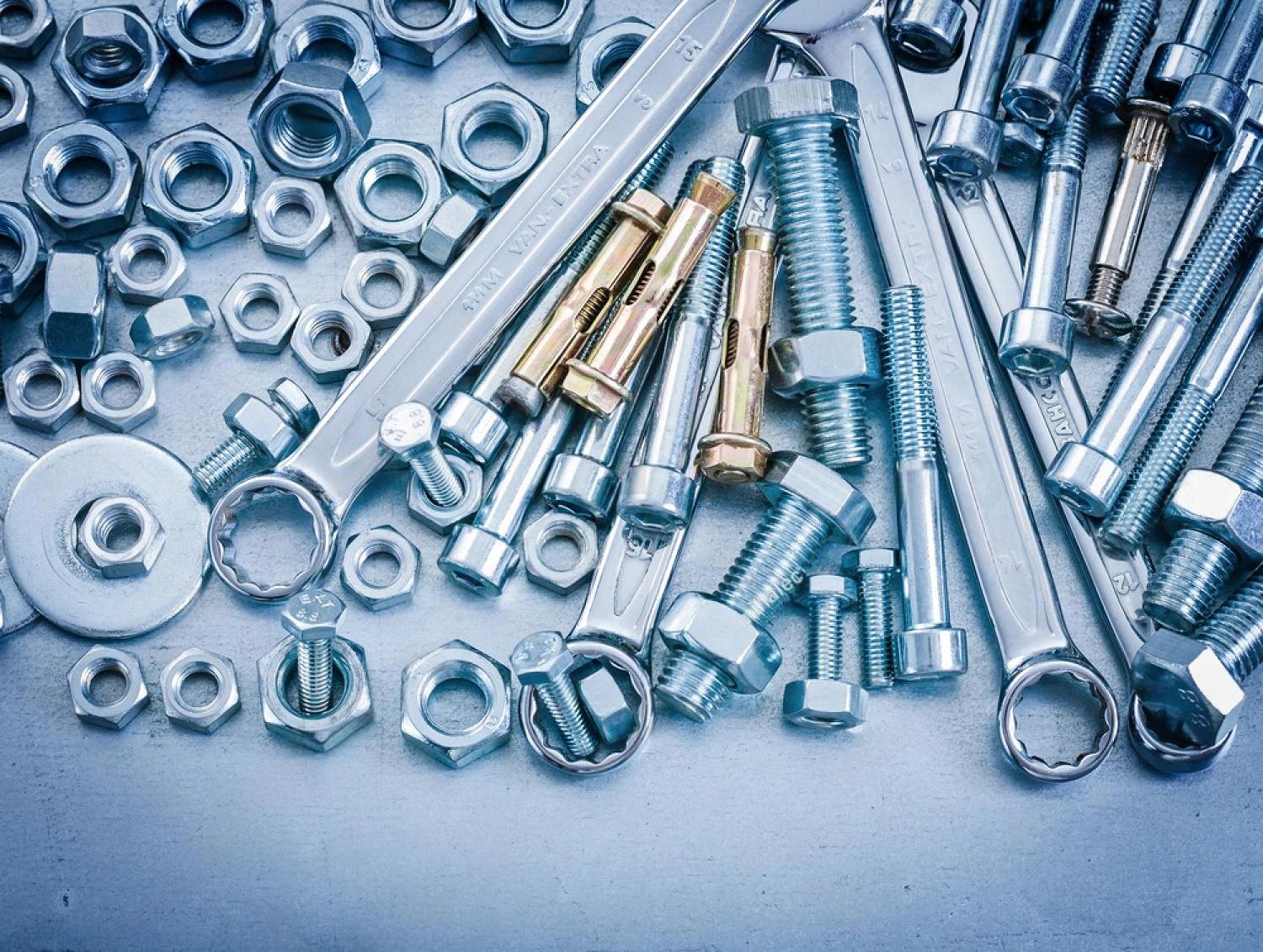Assortment of anchor bolts, nuts and wrenches used when securing a safe locker in the UAE