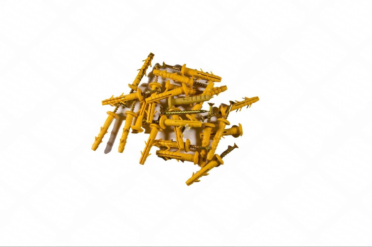 Pile of yellow plastic wall plugs and screws used for anchor fastening a home safe
